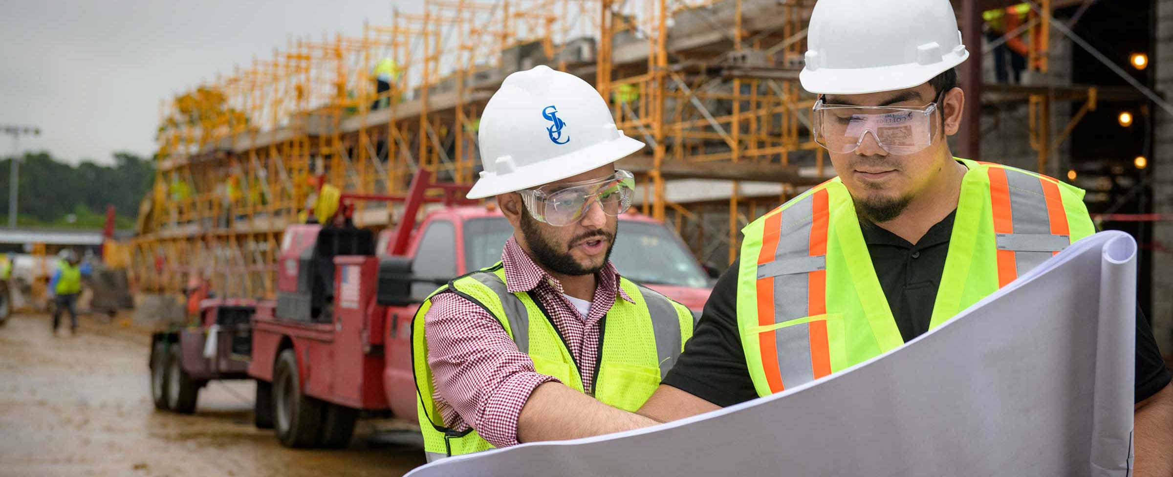 Construction Management students reviewing blueprints