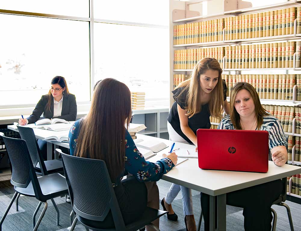 Paralegal students working in a library