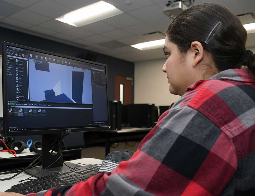 game design student working on a computer