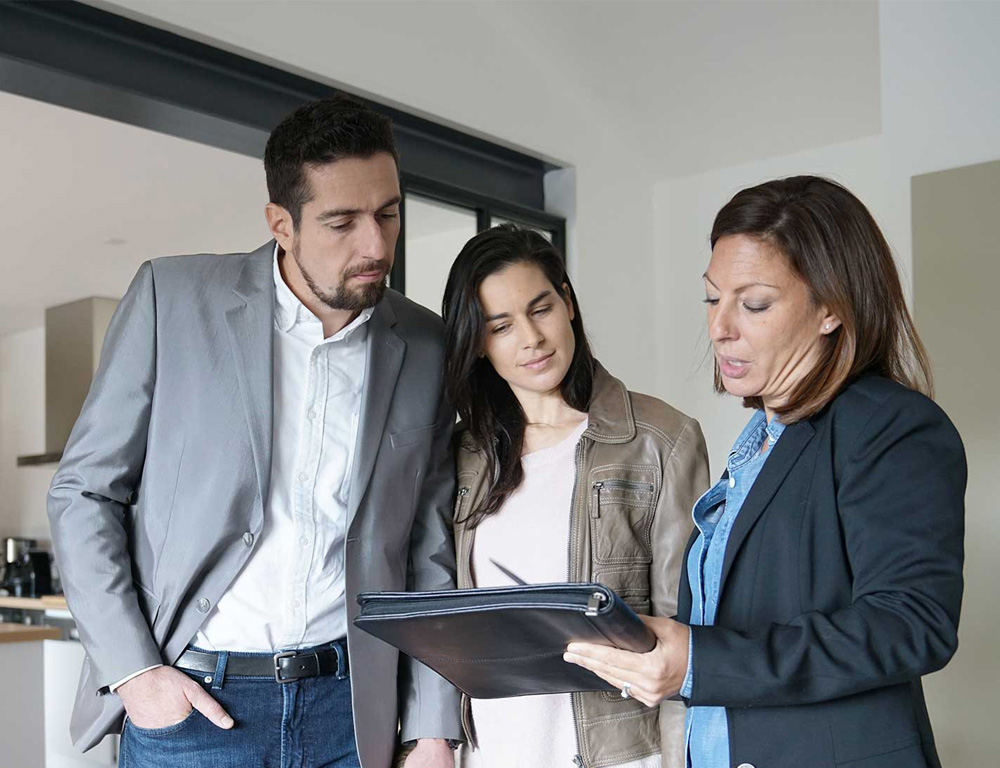 Family meeting with a real estate agent in a home for sale