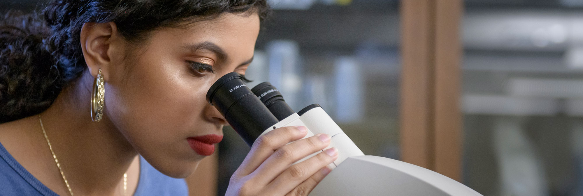 Student looking through microscope