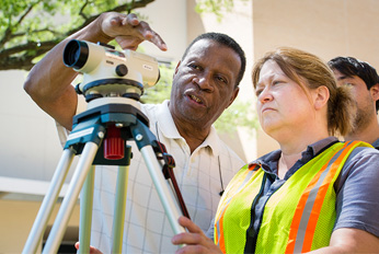 Construction Management students looking at a building plan