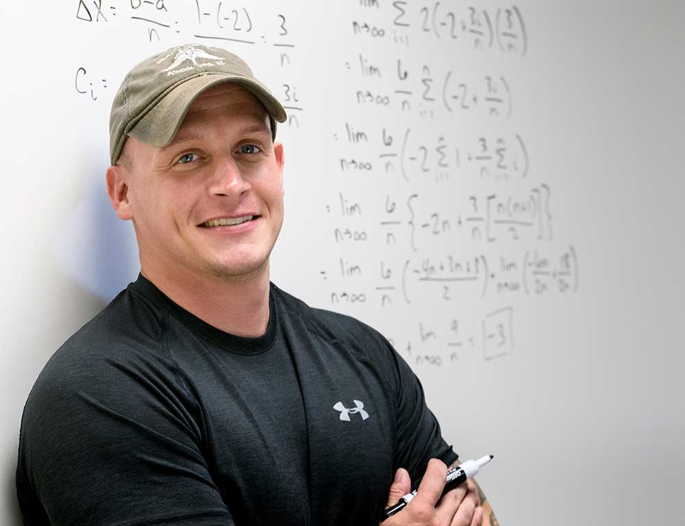 Mathematics instructor in front of whiteboard